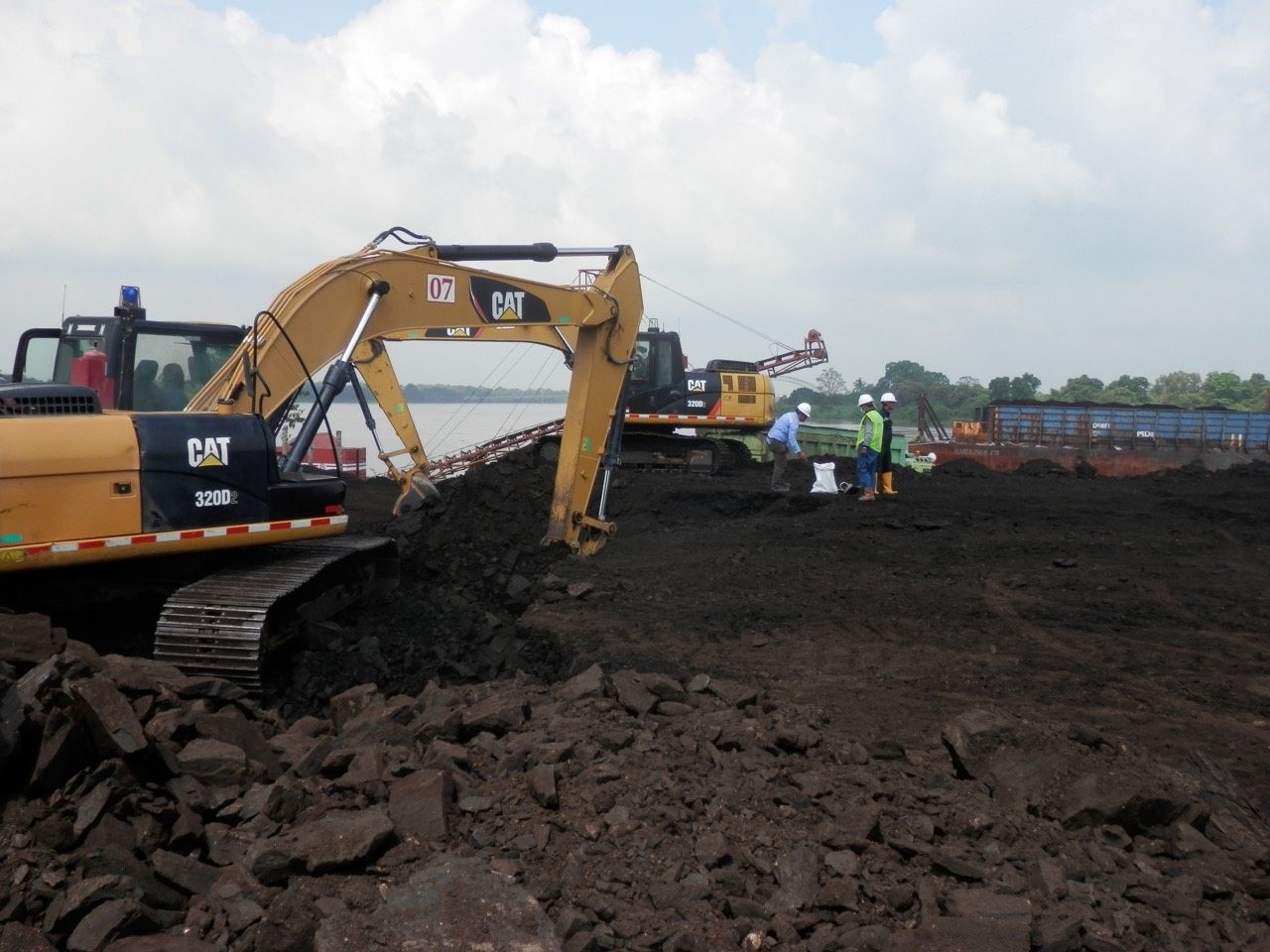 Excavators loading coal at the river jetty